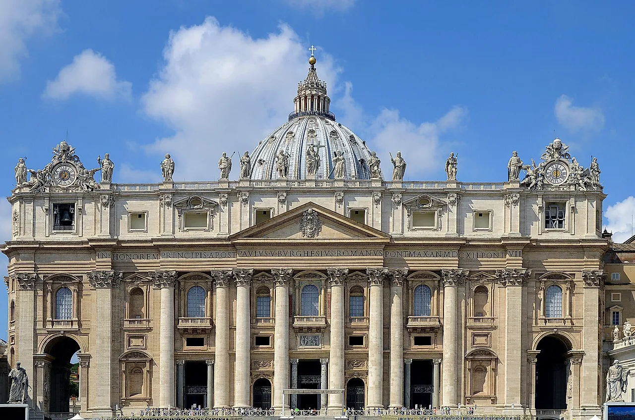 The Baroque facade of St Peter's Basilica with its giant columns, the attic with statues and the central balcony